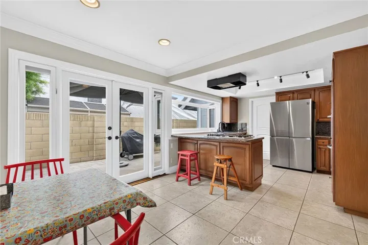 Plenty of casual dining space and double door access to the side/backyard
