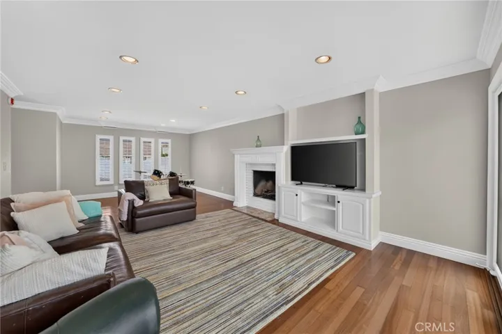 Spacious family room centered around a cozy gas fireplace.
