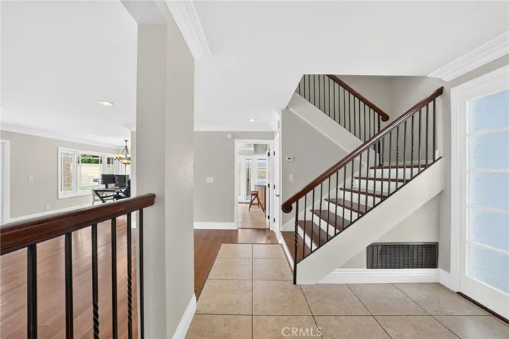 Open hallway connects the kitchen, living room, and stairway.