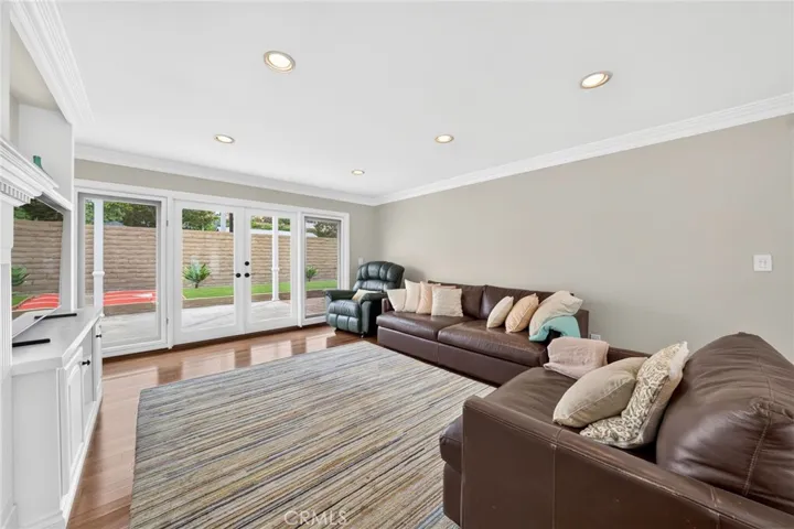 Natural light and backyard access through double doors enhance the room’s open atmosphere.