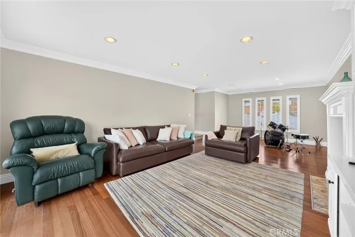 Recessed lighting and crown molding carry throughout the room.
