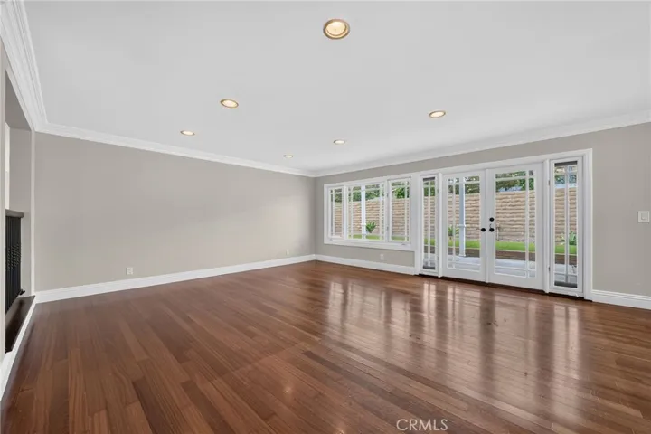 Spacious living room filled with natural light from a wall of windows/doors.