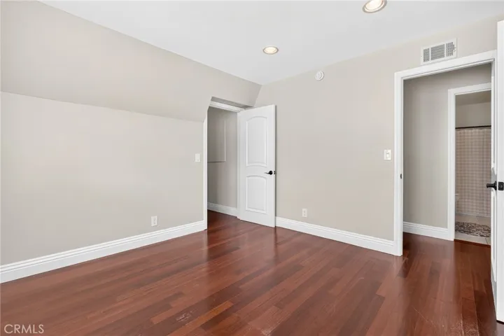 Nicely sized secondary bedroom with wood flooring and natural light.
