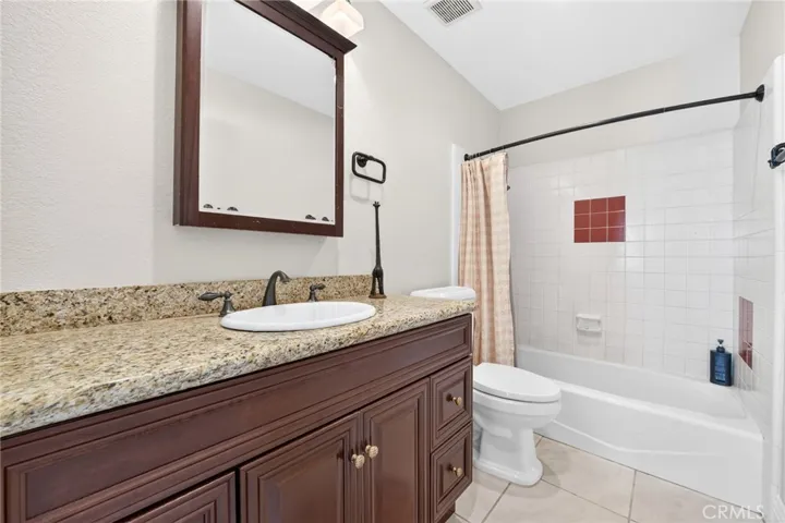 Full hallway bathroom with a convenient shower and tub combination.
