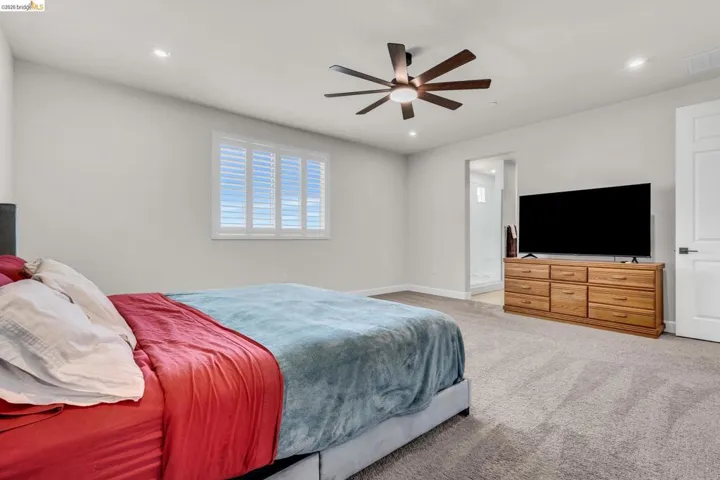 Bedroom featuring light gray walls and plush gray carpeting
