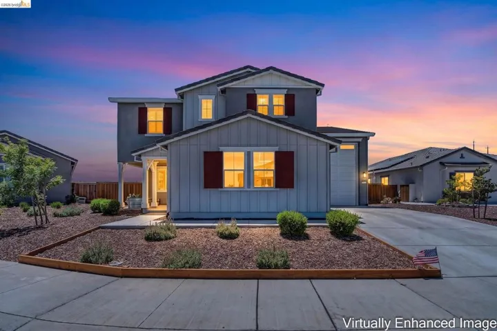 Two-story residence featuring a covered front porch entry, board and batten siding, and decorative window shutters