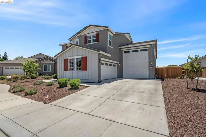 Contemporary stucco and siding exterior with red window shutters