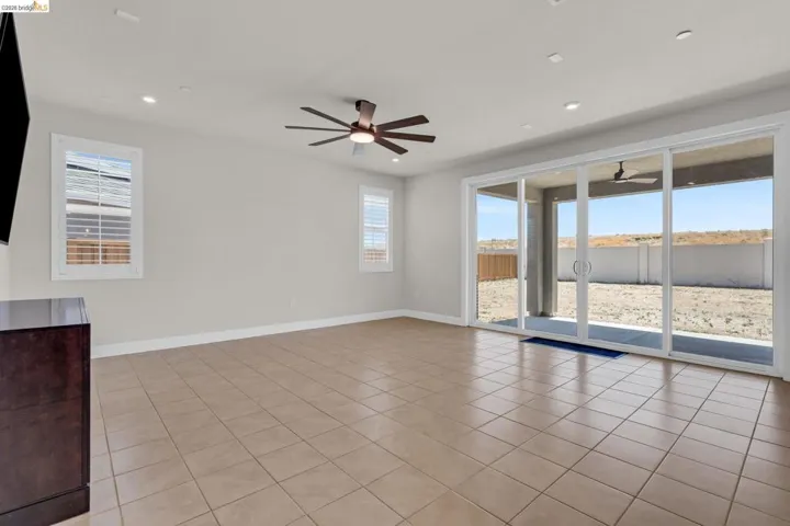 Spacious interior featuring neutral walls, recessed lighting, and a ceiling fan