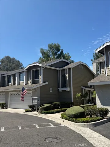 Well-maintained front exterior featuring mature landscaping and an attached garage.