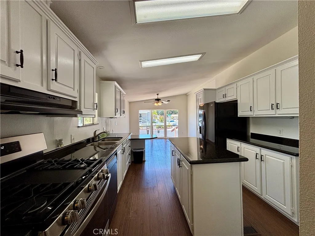 Updated kitchen with white cabinets and granite-look countertops