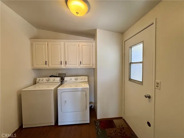 Separate laundry room with newer cabinets