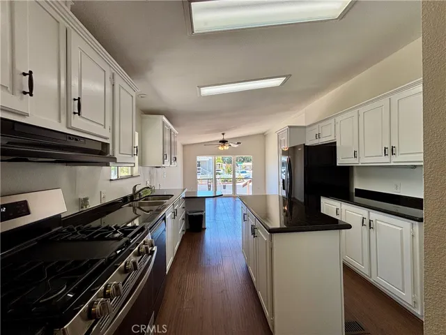 Updated kitchen with white cabinets and granite-look countertops