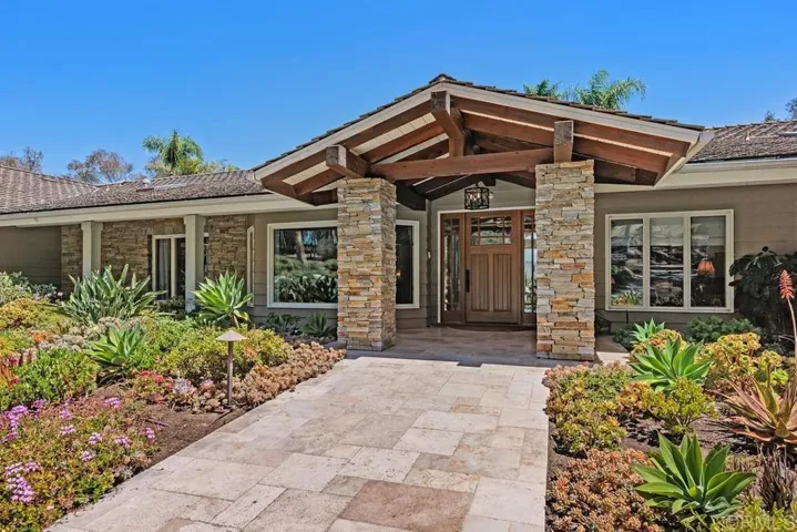 Drive through eucalyptus trees to arrive at a circular driveway and the front door.
