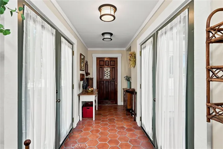 Double french doors open to front porch and back patio