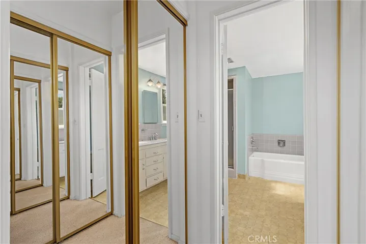 DOUBLE CLOSET LEADING TO BATHROOM