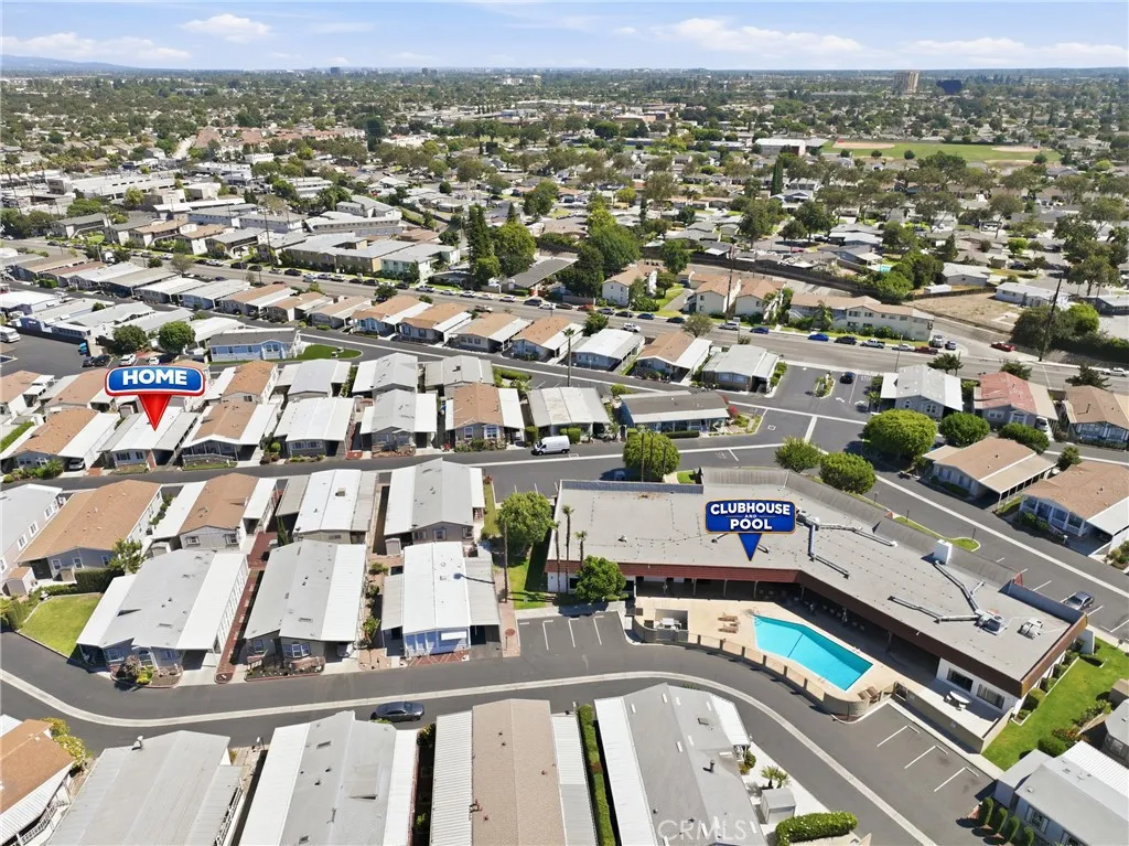 Aerial drone view highlighting the home’s convenient location just steps from the clubhouse and community pool.