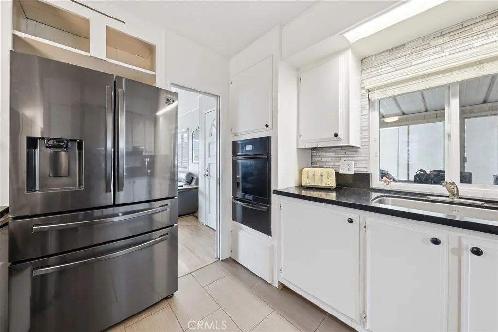 The kitchen features stainless steel appliances, offering both style and functionality.
