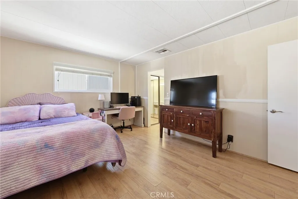Take a look at this spacious primary bedroom, offering plenty of room for comfort and relaxation