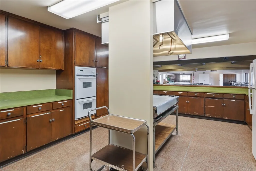 The spacious clubhouse kitchen offers abundant cabinetry and plenty of room for preparing and serving meals.