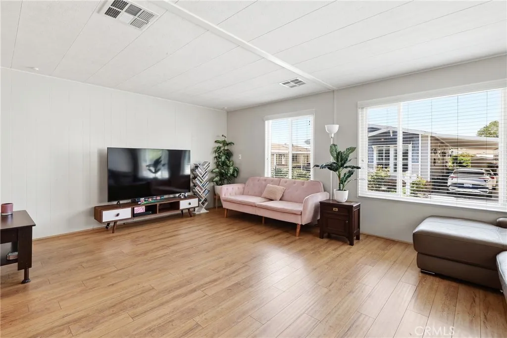 This spacious living room offers an abundance of natural light, creating a bright and welcoming atmosphere.
