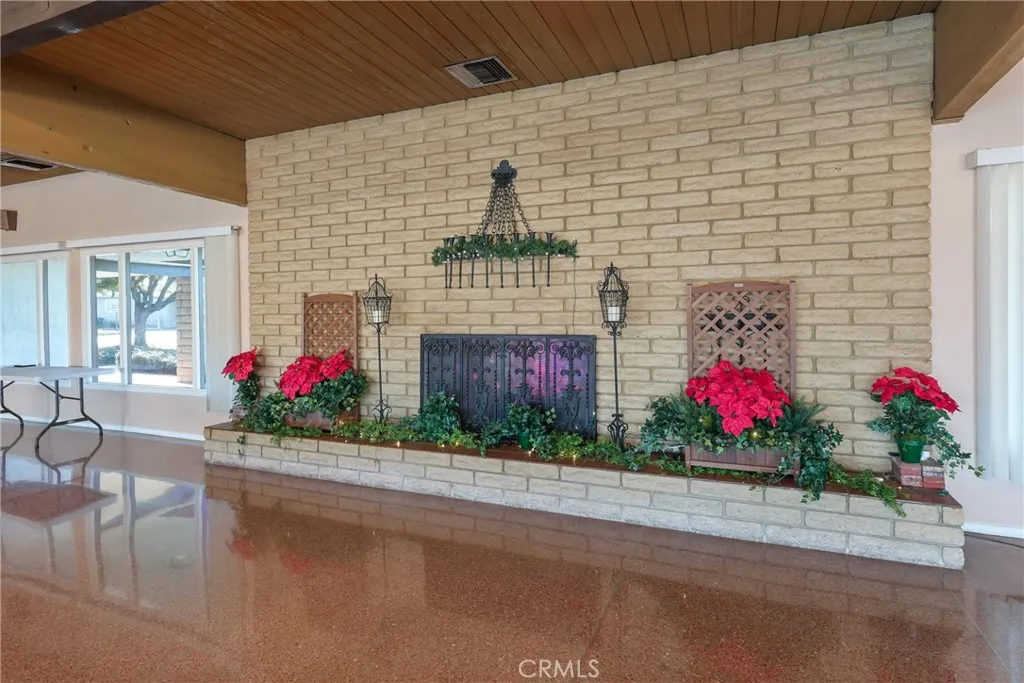 The spacious clubhouse entrance features a cozy fireplace and plenty of comfortable seating.