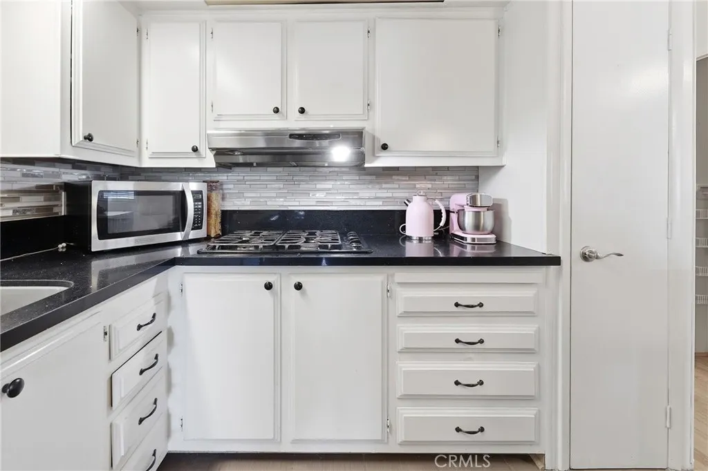 An abundance of  storage and a stylish mosaic tile backsplash.
