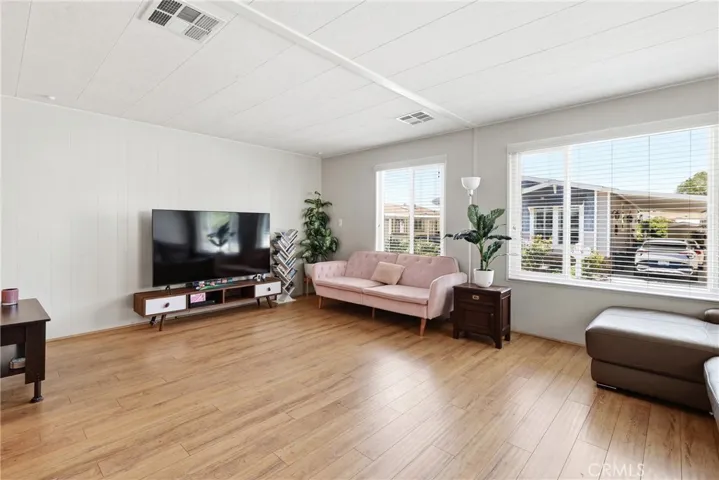 This spacious living room offers an abundance of natural light, creating a bright and welcoming atmosphere.