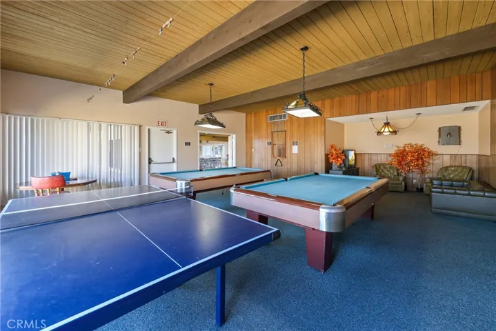 The clubhouse game room features a ping-pong table and billiards tables for recreation and friendly competition.