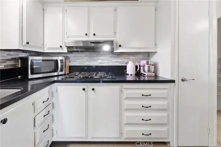 An abundance of  storage and a stylish mosaic tile backsplash.