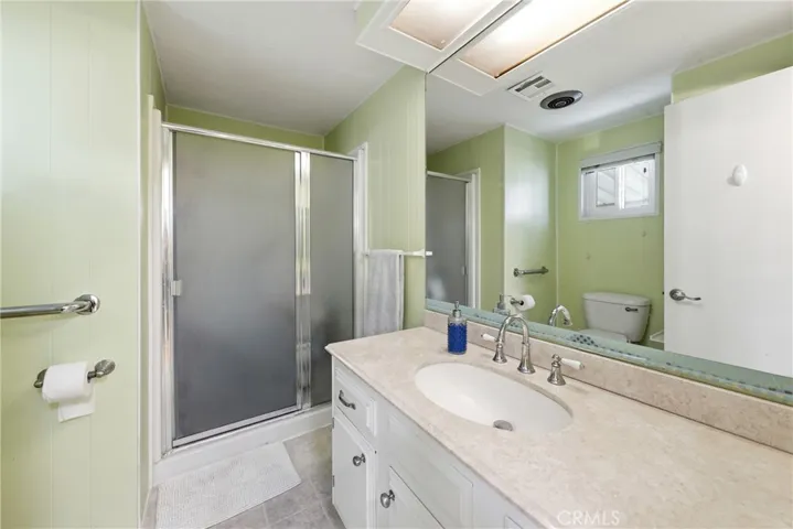 The three-quarter bathroom features a bidet toilet and a convenient closet for additional storage.