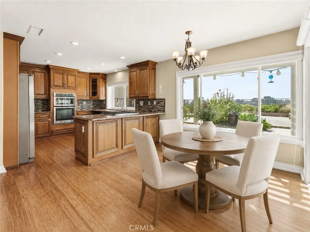 Breakfast nook and kitchen, digitally staged