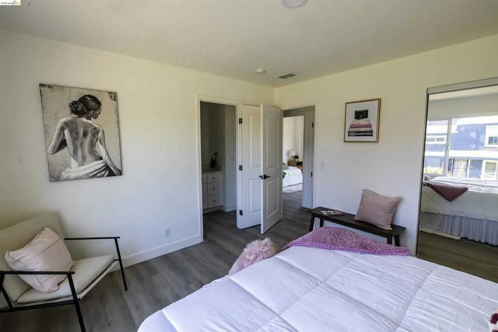 Spacious bedroom featuring light wood-finish flooring and recessed ceiling lighting