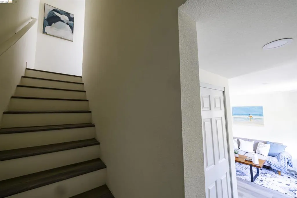 Staircase featuring wood-finish treads and white risers