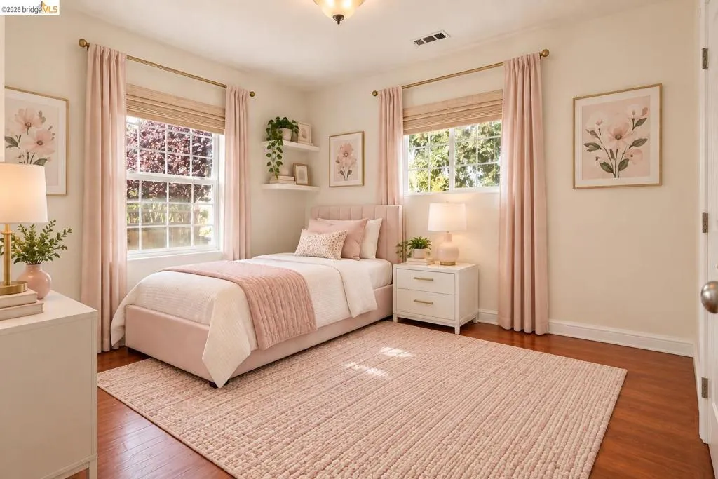 Hardwood flooring, painted walls, two large windows, white trim, and a ceiling-mounted light fixture