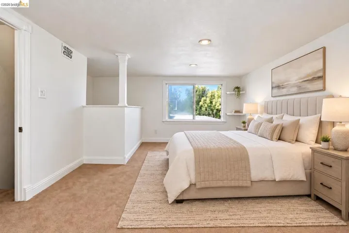 Recessed lighting, wood-trim windows, and wall shelving