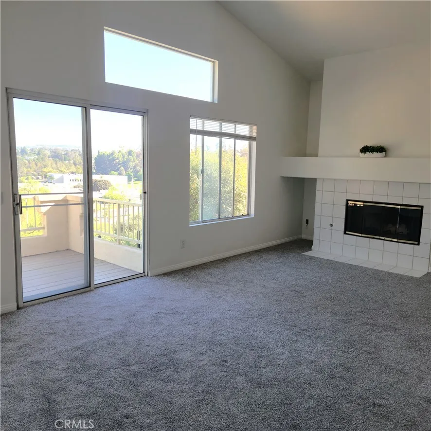 Primary suite with vaulted ceiling, fireplace and balcony