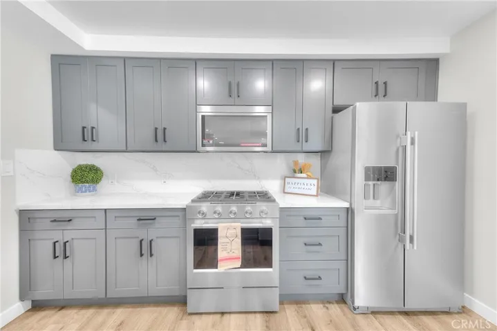 Kitchen: New Quartz countertop. New cabinetry, New KitchenAid Appliances.