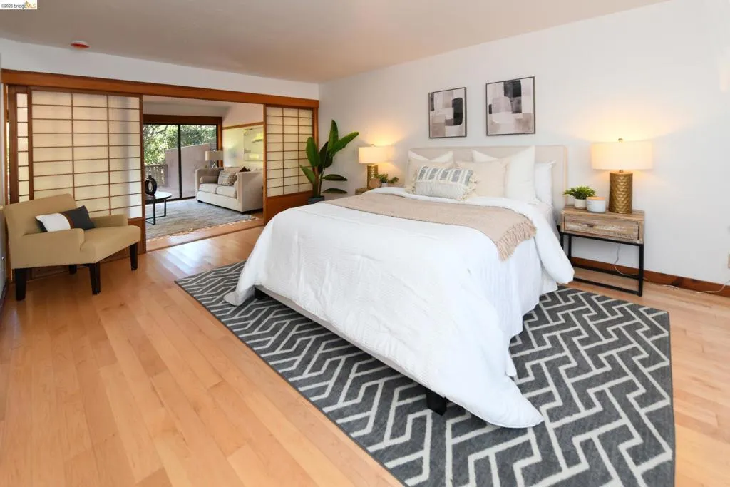 Hardwood flooring throughout, featuring Shoji screens creating a flexible division from the sitting area