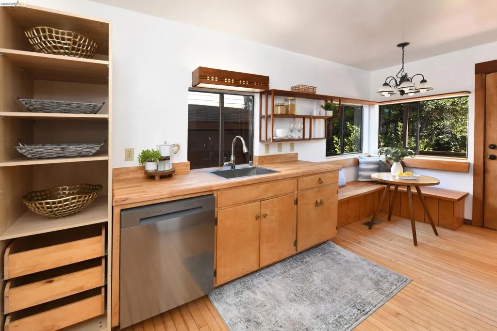 Kitchen space featuring light wood cabinetry and countertops