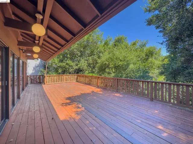 Expansive wood-finish deck with a wood railing system