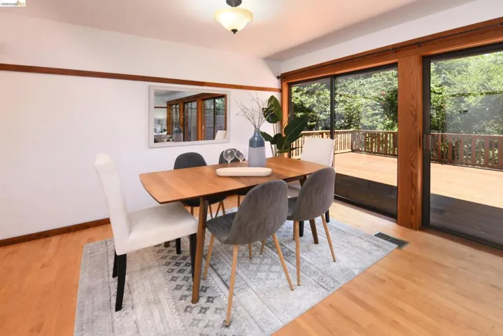 Hardwood flooring throughout, with a large sliding glass door opening to an expansive outdoor deck