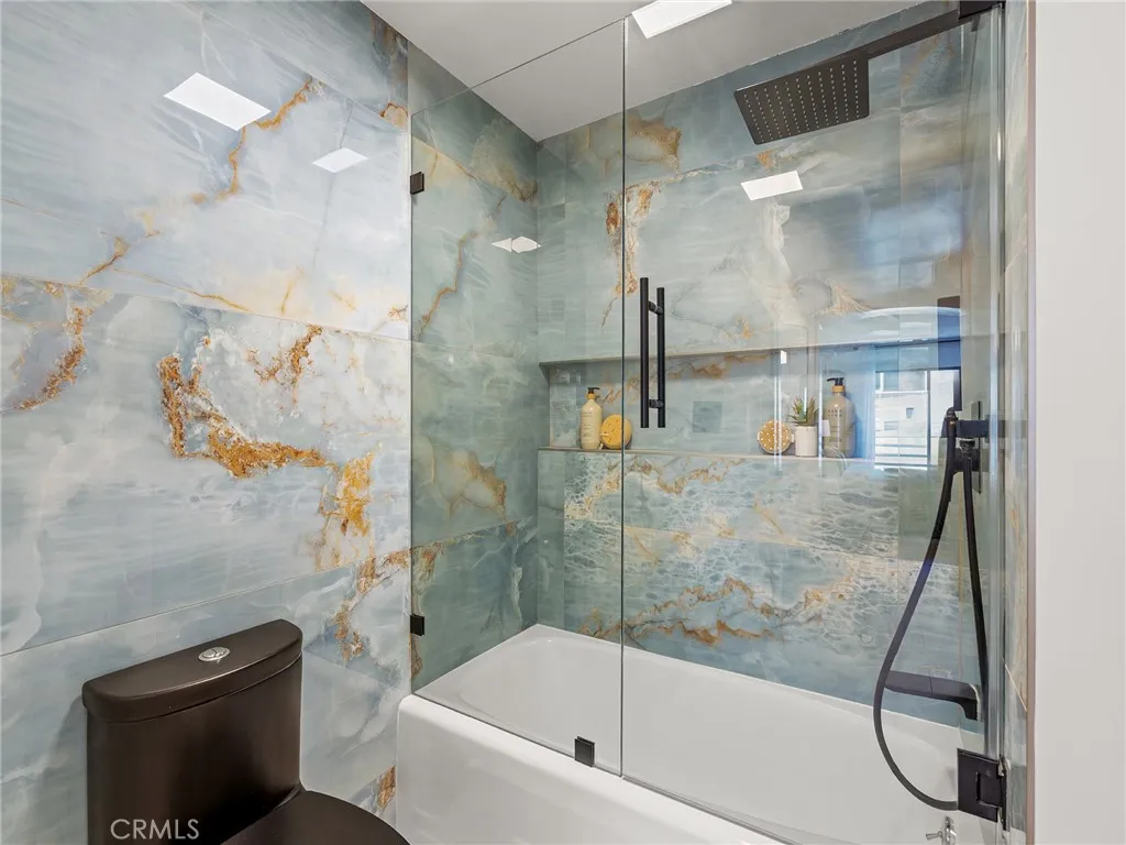 The tile work is amazing and the glass enclosed tub and shower with dual heads are the perfect addition.