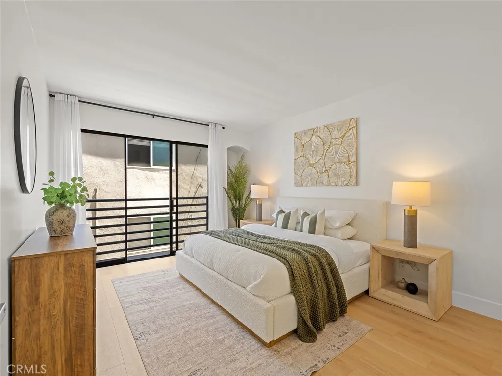 The primary bedroom, with Juliet balcony, is so perfectly appointed and the building is separated by distance that adds privacy.