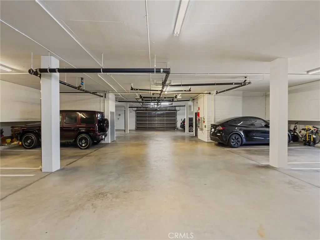 A clean, well lit, secure, subterranean gated garage with assigned parking