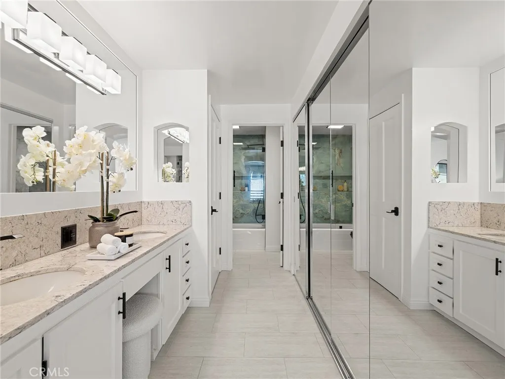 This could be your primary suite with dual sinks and mirrored closets and a tub and shower.