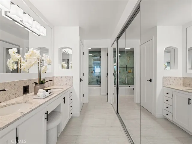 This could be your primary suite with dual sinks and mirrored closets and a tub and shower.