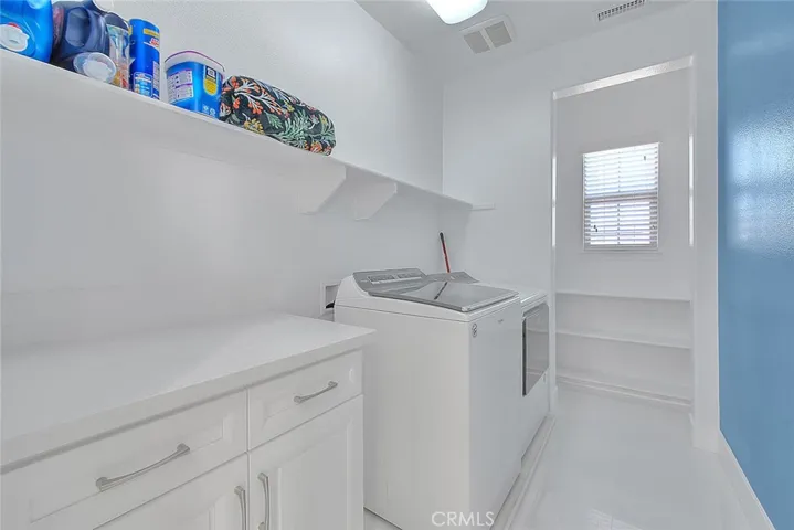 Upstairs laundry room with additional storage space