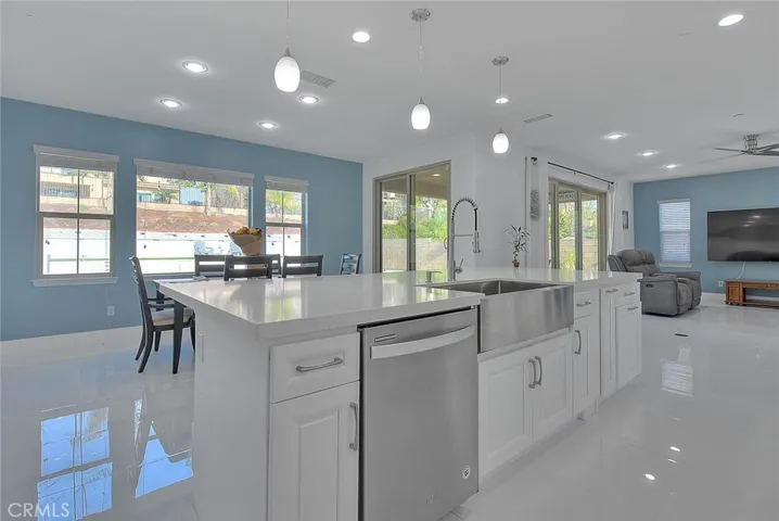 Oversized island with sink and bar top dining