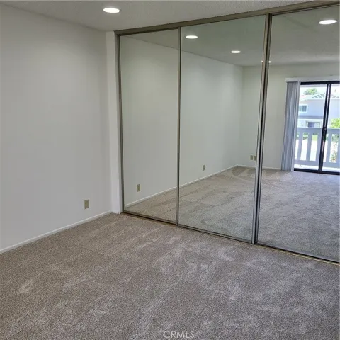 Primary bedroom with mirrored wardrobe doors