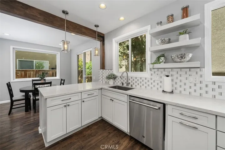 Spacious kitchen with an oversized peninsula, generous prep space, and views into the dining area.